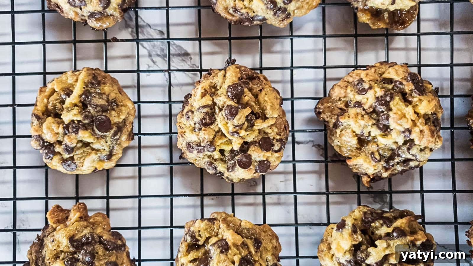21 Snack Swaps That Beat Junk Food Without Sacrificing Flavor 15 Keto magic cookies cooling on a black wire rack over a marble surface.