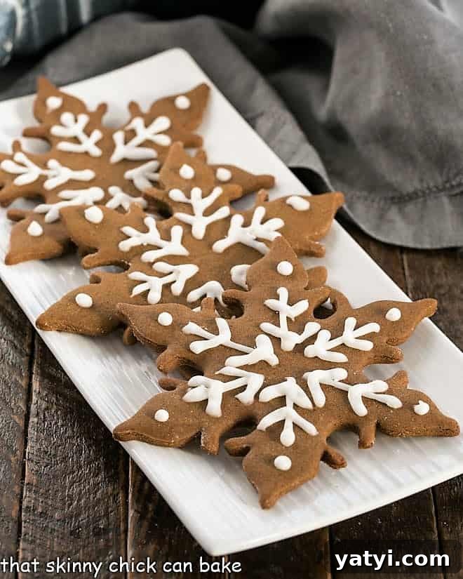 Classic Homemade Gingerbread Recipe: Perfect for Holiday Baking 2 3 gingergread snowflakes on a white platter.