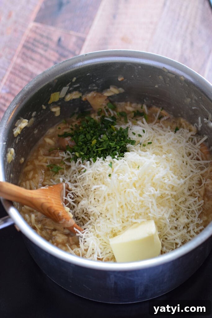 Creamy Mushroom and Leek Risotto Recipe for Cozy Dinners 13 Adding cheese, parsley and butter to risotto in a saucepan.