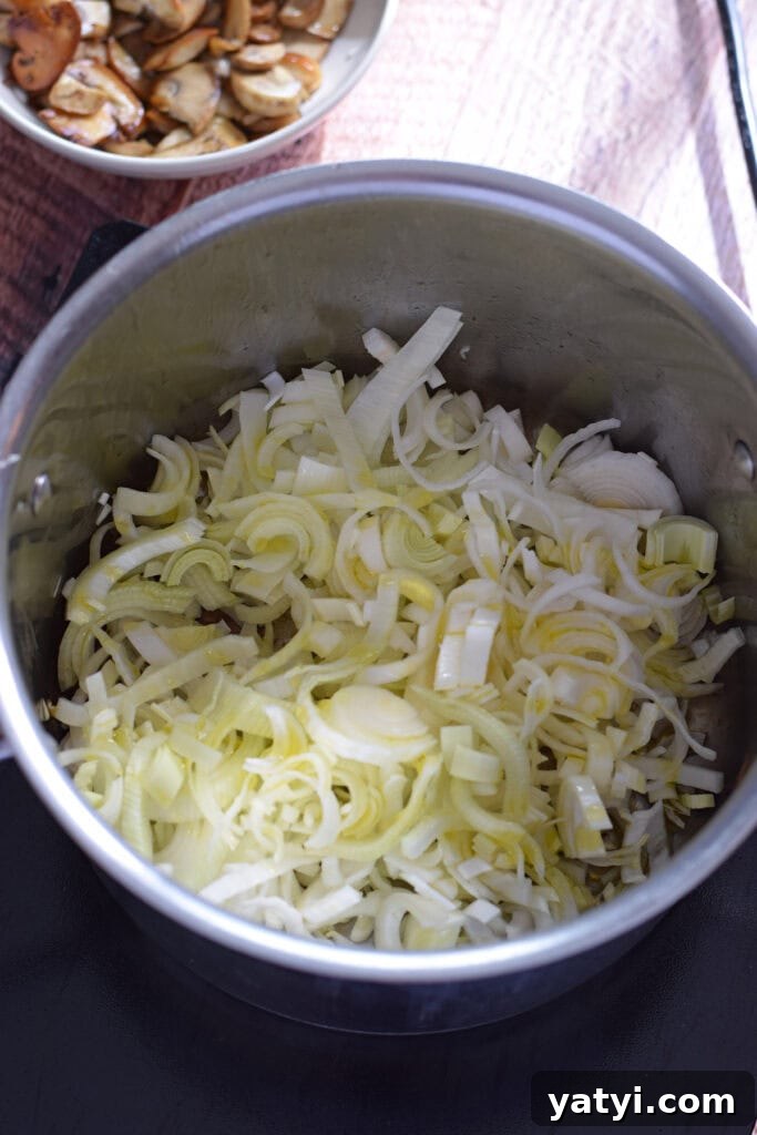 Creamy Mushroom and Leek Risotto Recipe for Cozy Dinners 8 Adding leeks to a saucepan.