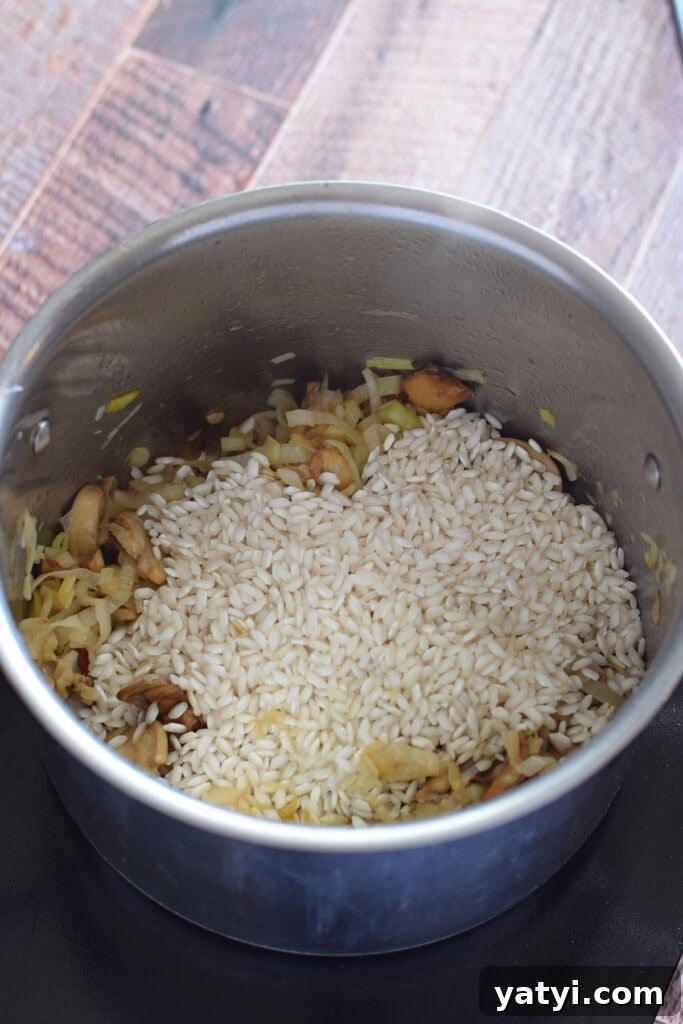 Creamy Mushroom and Leek Risotto Recipe for Cozy Dinners 10 Adding rice to a saucepan.