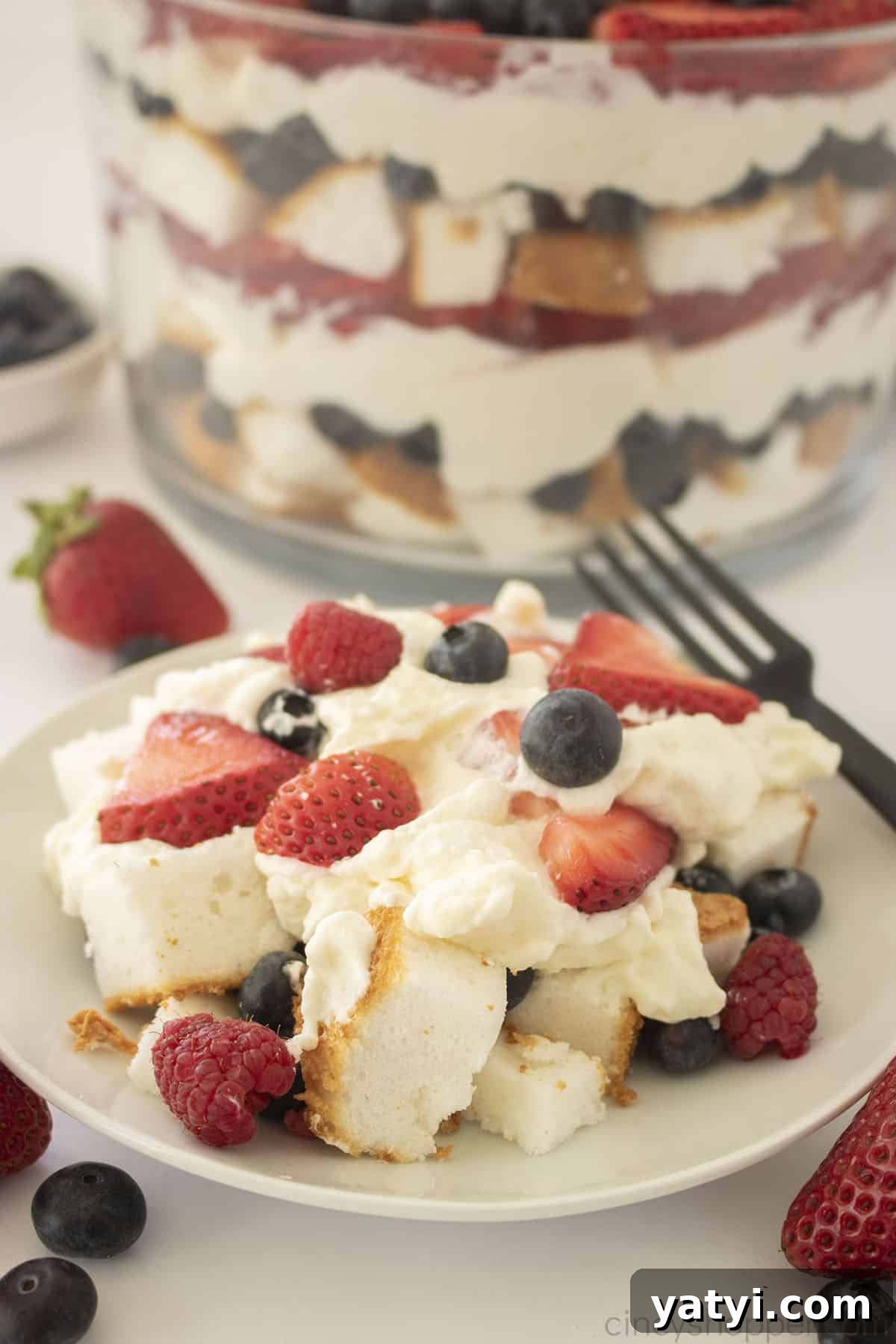 Berry Trifle Recipe: Layered Summer Dessert with Fresh Berries 3 Triple Berry trifle on a white plate.