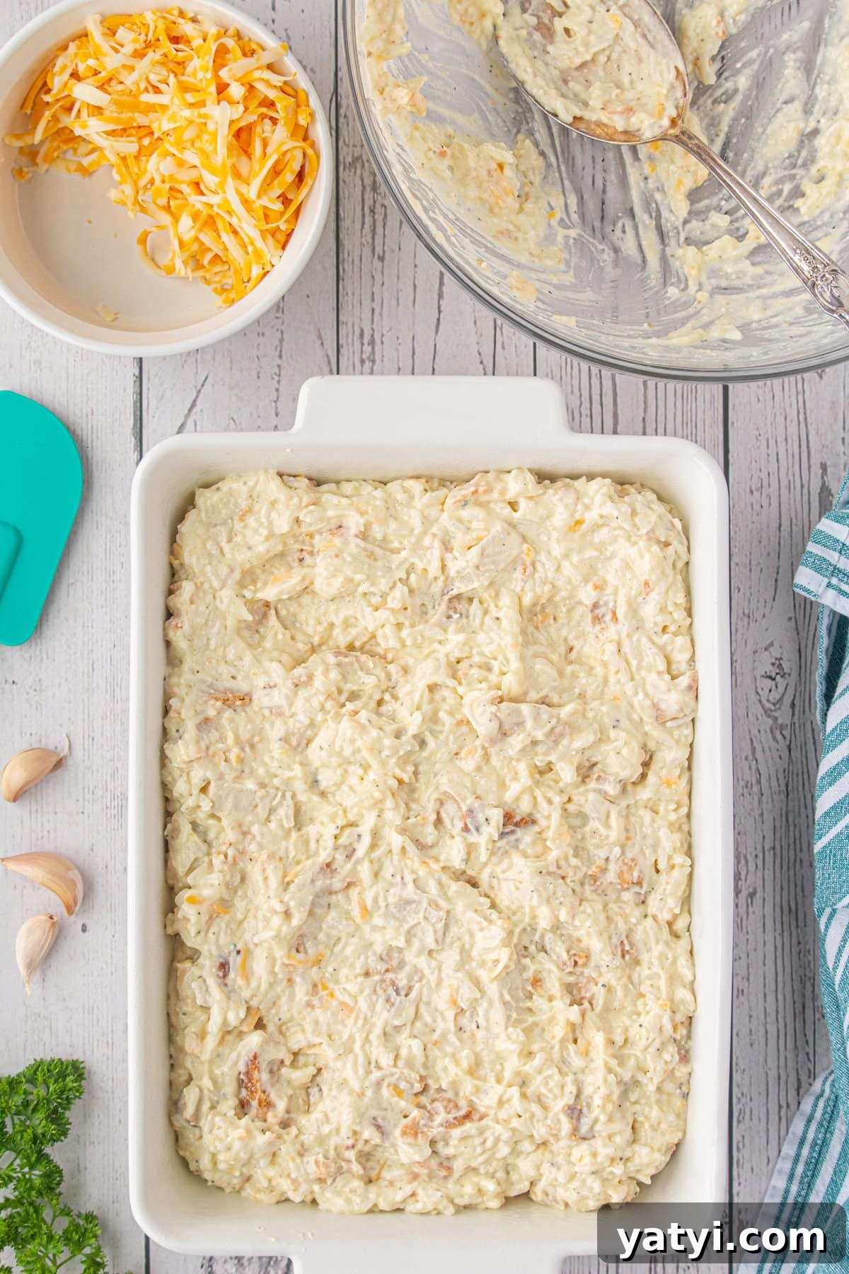 Creamy Angel Chicken and Rice Casserole Recipe 7 The chicken, rice, and cheese mixture spread in a casserole dish.