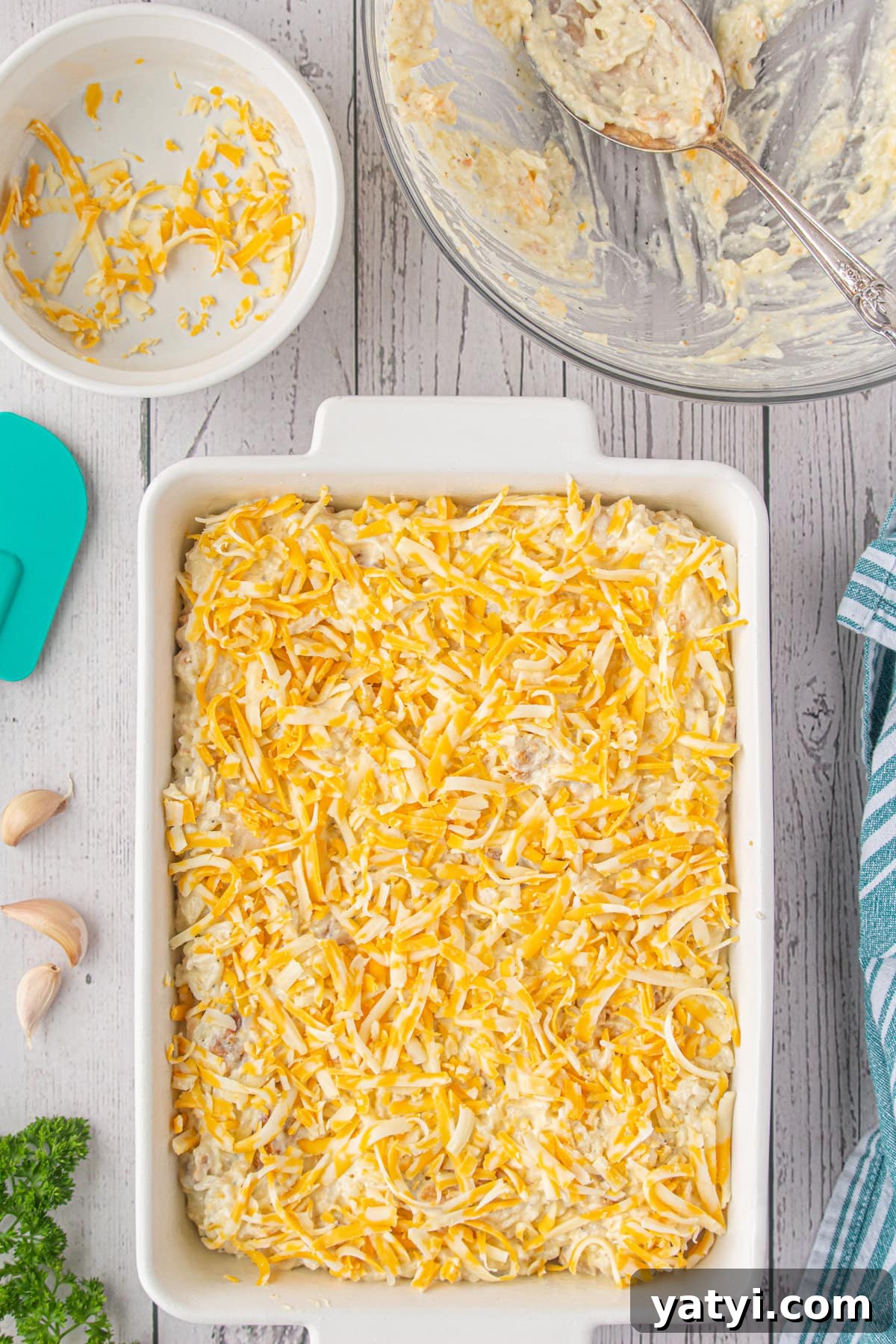 Creamy Angel Chicken and Rice Casserole Recipe 8 The unbaked casserole topped with more cheese.