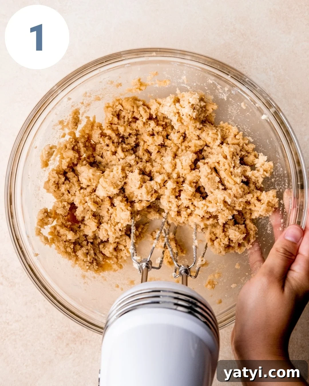 Ultimate Chewy Chocolate Chip Cookie Recipe 4 Mixing wet cookie ingredients in a bowl with a hand mixer.
