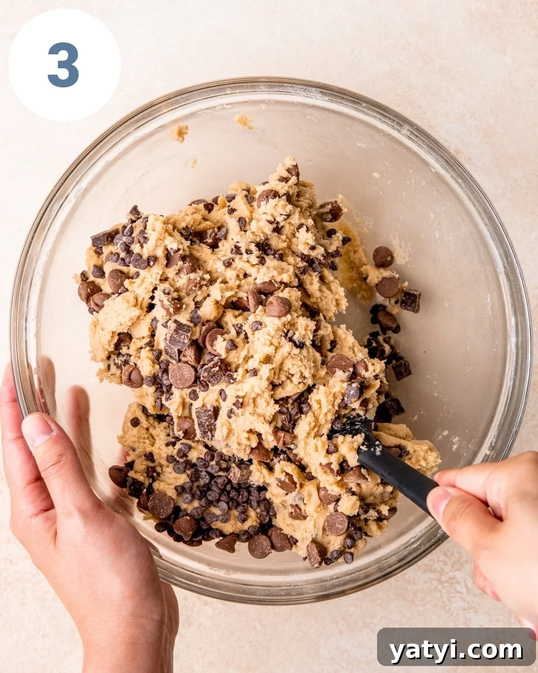 Ultimate Chewy Chocolate Chip Cookie Recipe 6 Stirring chocolate chip cookie dough with a spatula.