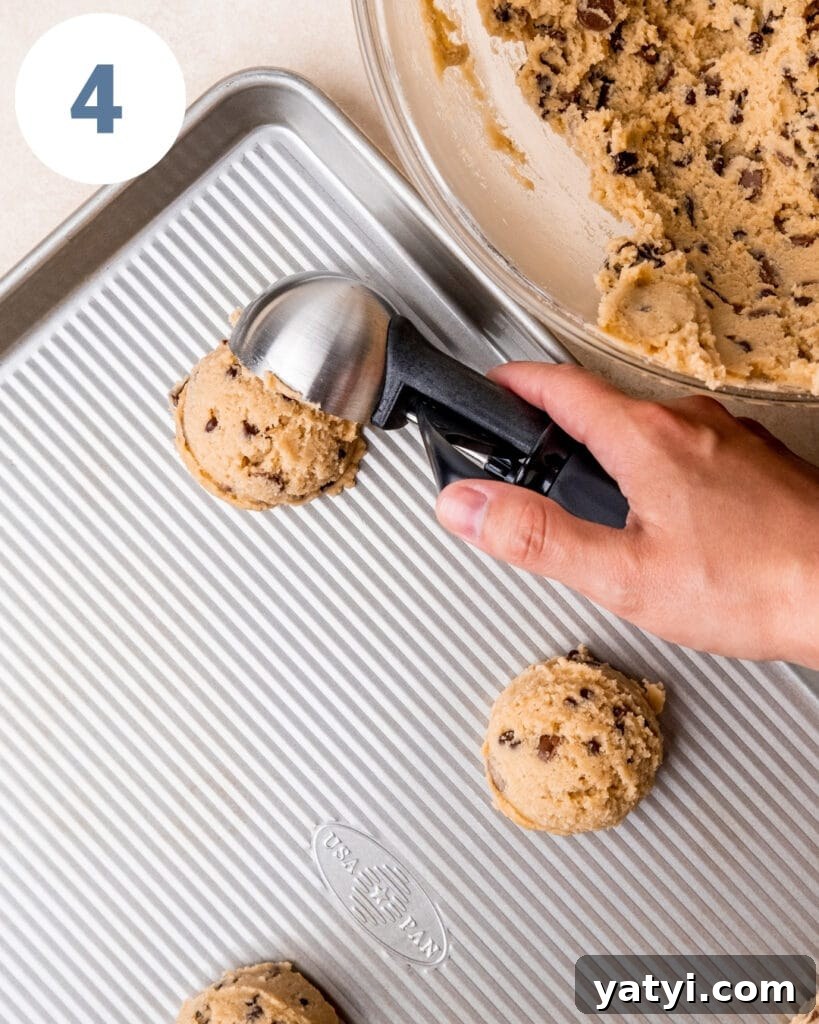 Ultimate Chewy Chocolate Chip Cookie Recipe 7 Scooping chocolate chip cookie dough onto a baking sheet.