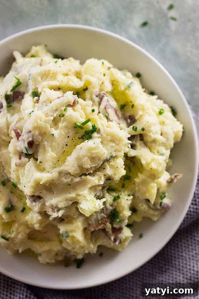 Creamy Chunky Mashed Potatoes with Rustic Texture 3 overhead closeup: a heaping bowl of rustic mashed potatoes with chives