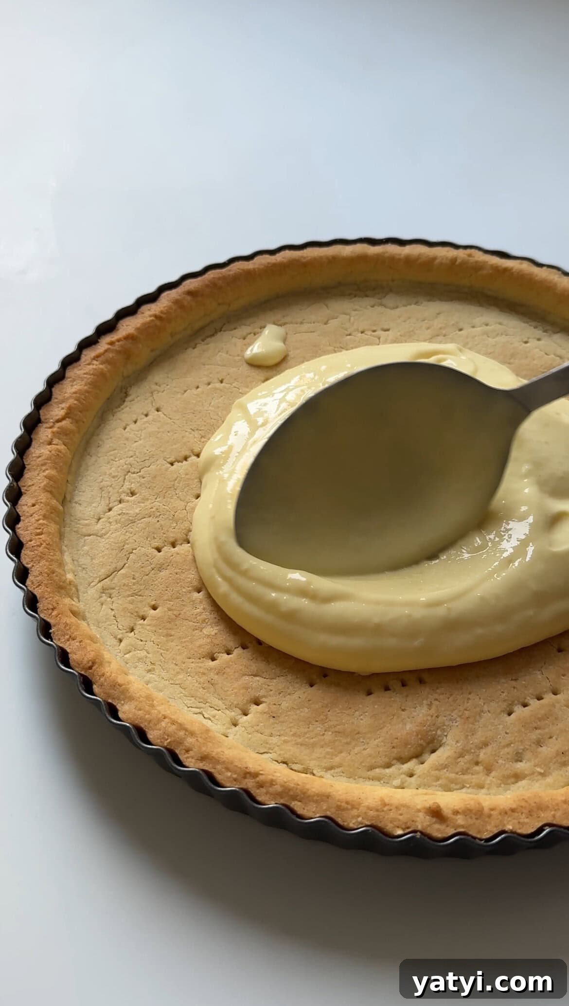 Lemon Meringue Tart Recipe with Crispy Crust and Fluffy Meringue 7 smoothing curd onto lemon meringue tart